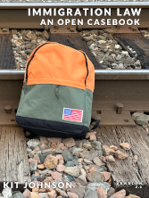 book cover of Immigration Law An Open Casebook showing orange-green backpack next to railroad tracks