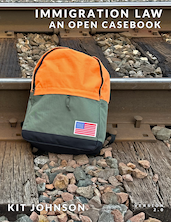 book cover of Immigration Law An Open Casebook showing orange-green backpack next to railroad tracks