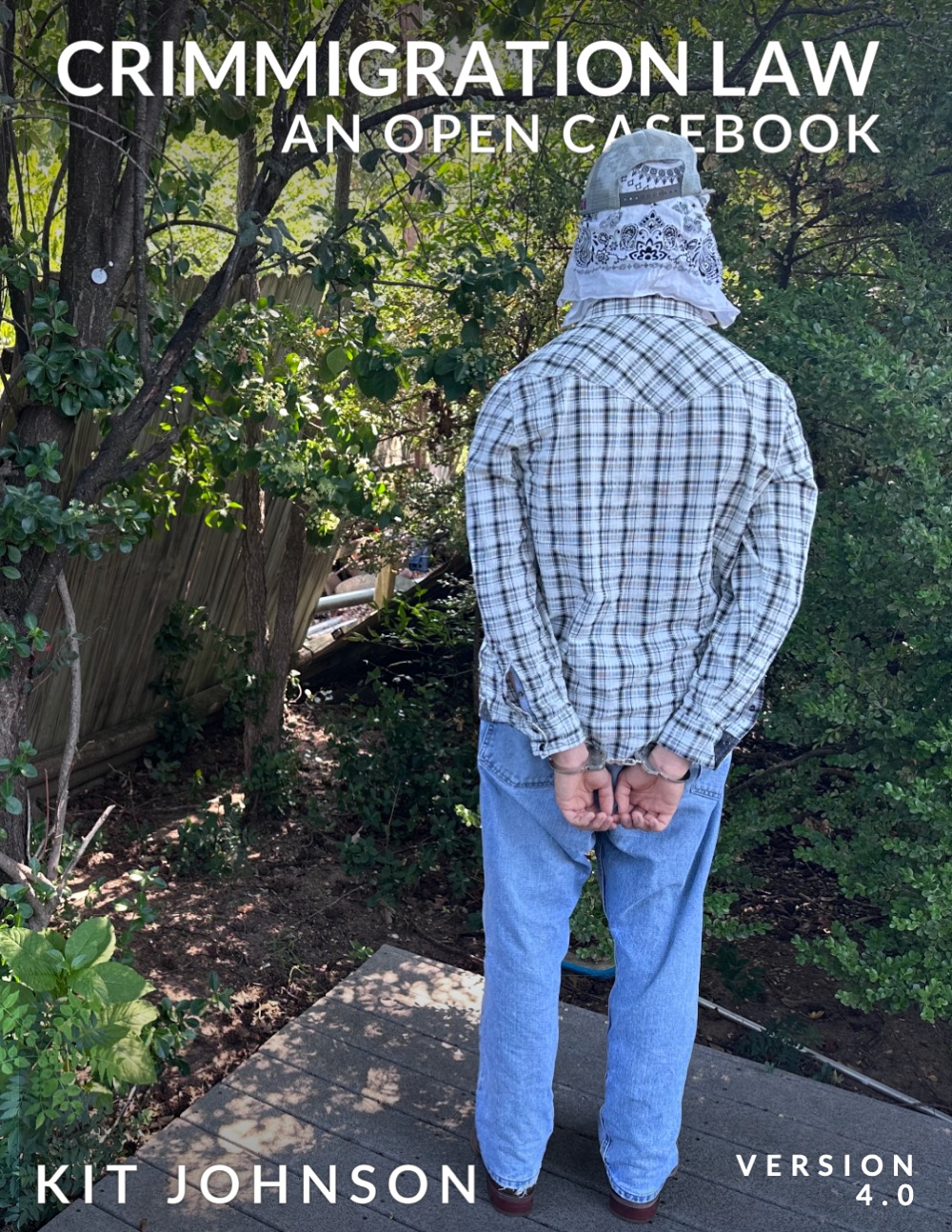 book cover of Crimmigration Law An Open Casebook showing a person facing away, in handcuffs